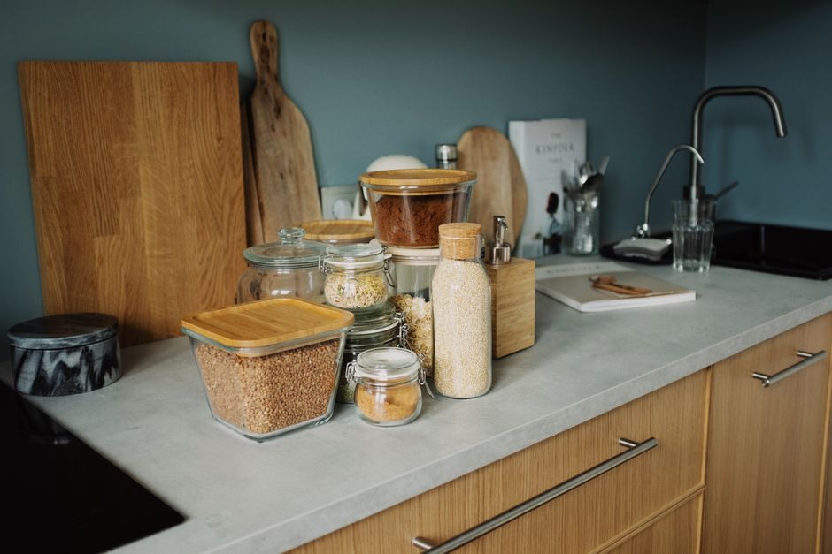 Quiet kitchen counter with jars, containers and everyday cooking items.