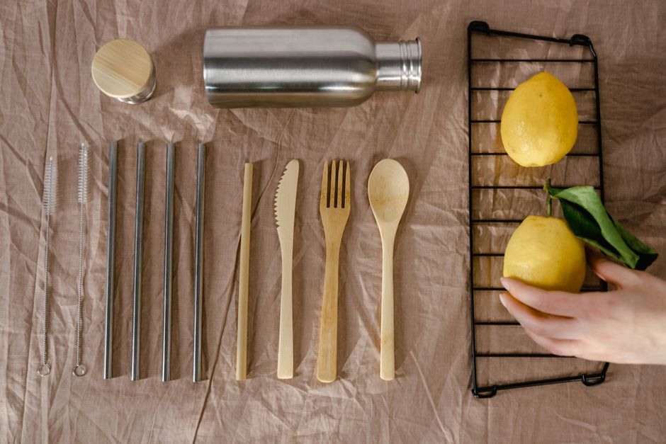 Simple wooden and metal kitchen utensils arranged neatly on a table.