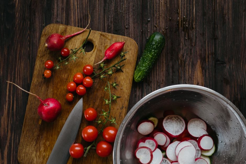 Fresh tomatoes, radishes and cucumbers arranged for simple cooking.